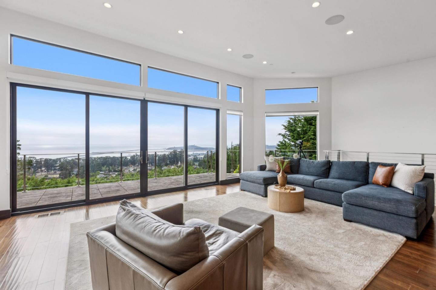 243 Del Monte Road El Granada, CA 94019 - Photo 15 of 66 a living room with furniture and a large window