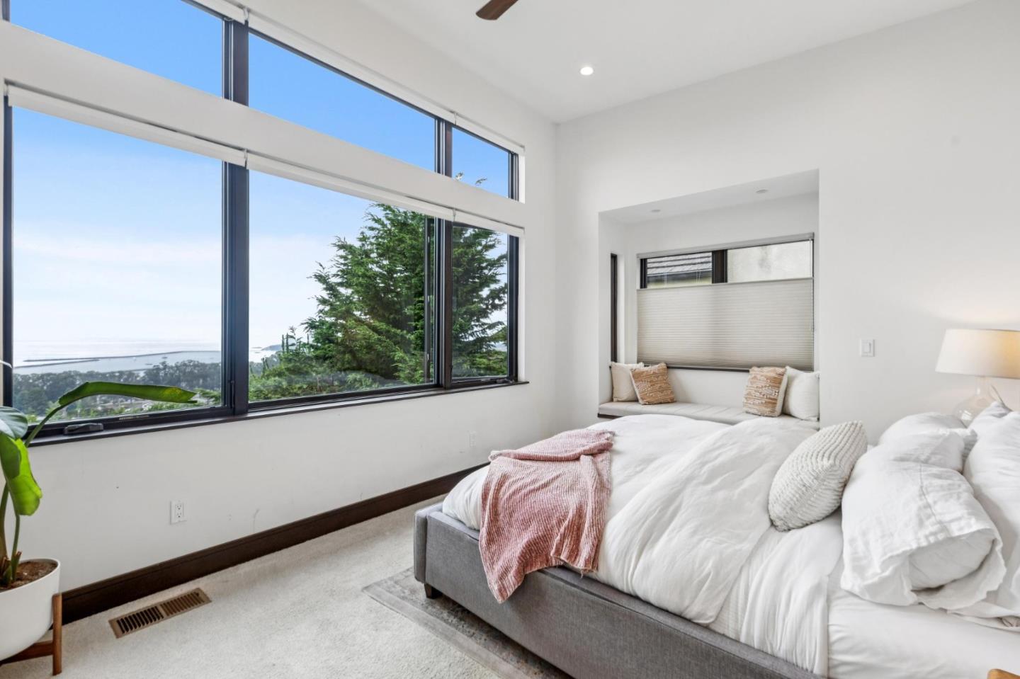 243 Del Monte Road El Granada, CA 94019 - Photo 26 of 66 a bedroom with a bed and a large window