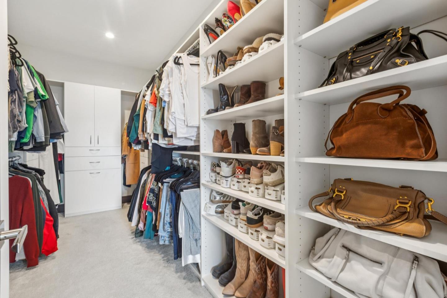 243 Del Monte Road El Granada, CA 94019 - Photo 31 of 66 a view of walk in closet with clothes and shoes