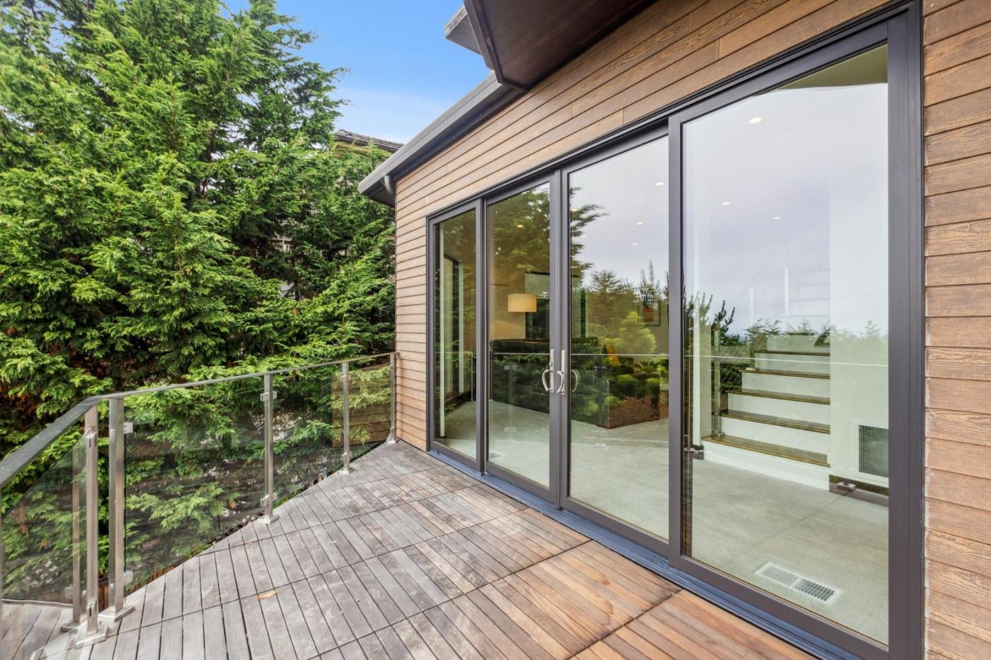 243 Del Monte Road El Granada, CA 94019 - Photo 42 of 66 a view of a balcony with floor to ceiling windows with wooden floor