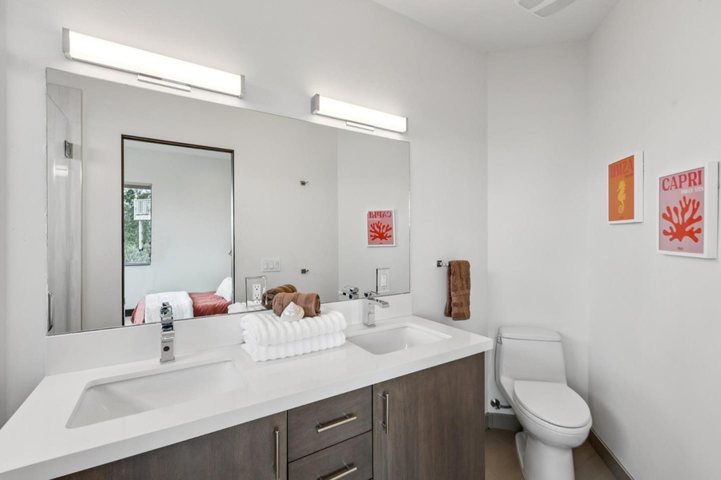 243 Del Monte Road El Granada, CA 94019 - Photo 45 of 66 a bathroom with a sink vanity mirror and toilet