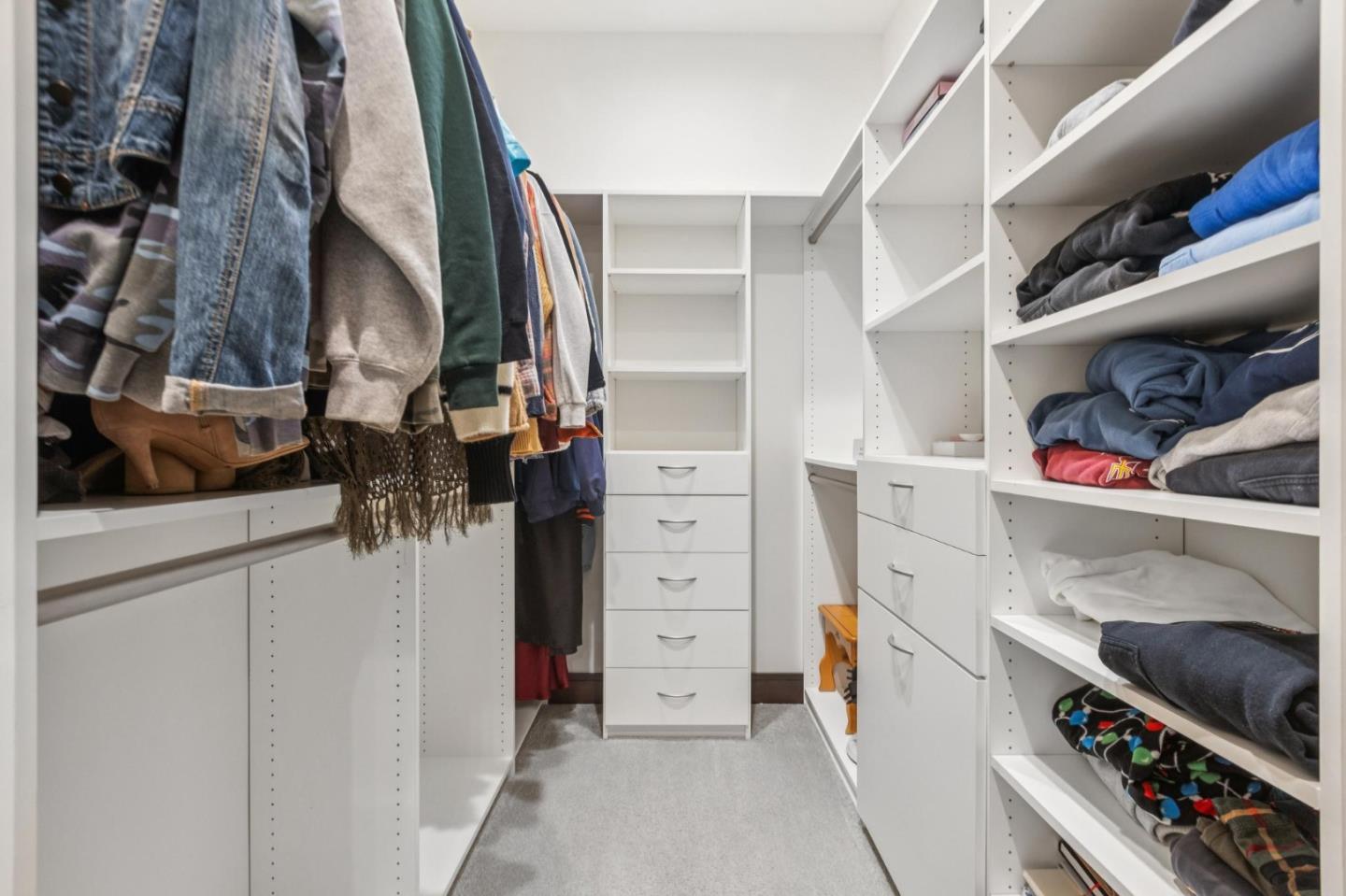 243 Del Monte Road El Granada, CA 94019 - Photo 47 of 66 a view of walk in closet with clothes and shoes