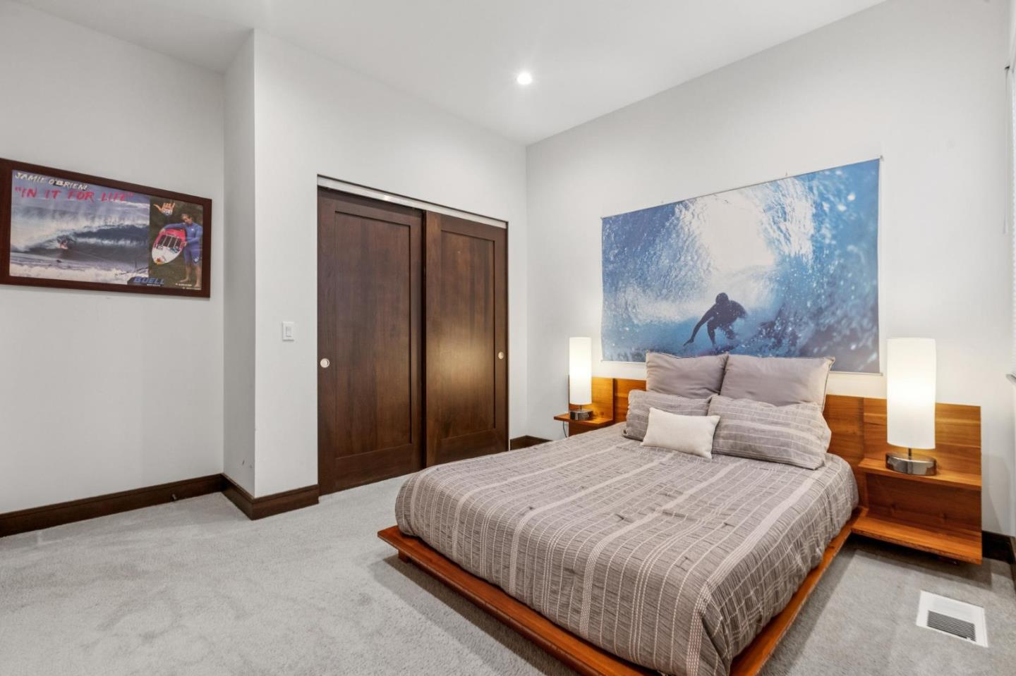 243 Del Monte Road El Granada, CA 94019 - Photo 52 of 66 a bedroom with a large bed and a painting on the wall