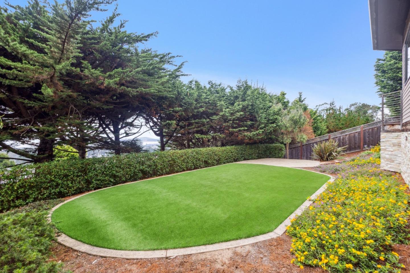 243 Del Monte Road El Granada, CA 94019 - Photo 62 of 66 a view of a swimming pool with a garden