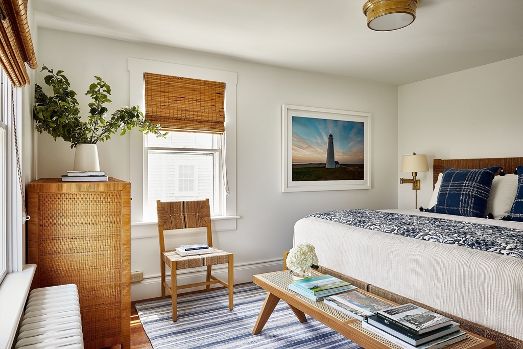3 North Beach Street Nantucket, MA 02554 - Photo 10 of 13 a bedroom with a bed and a potted plant