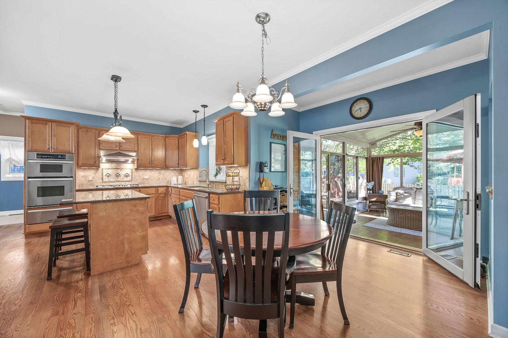 2816 Cordgrass Road Naperville, IL 60564 - Photo 13 of 49 a dining room with furniture a chandelier and wooden floor