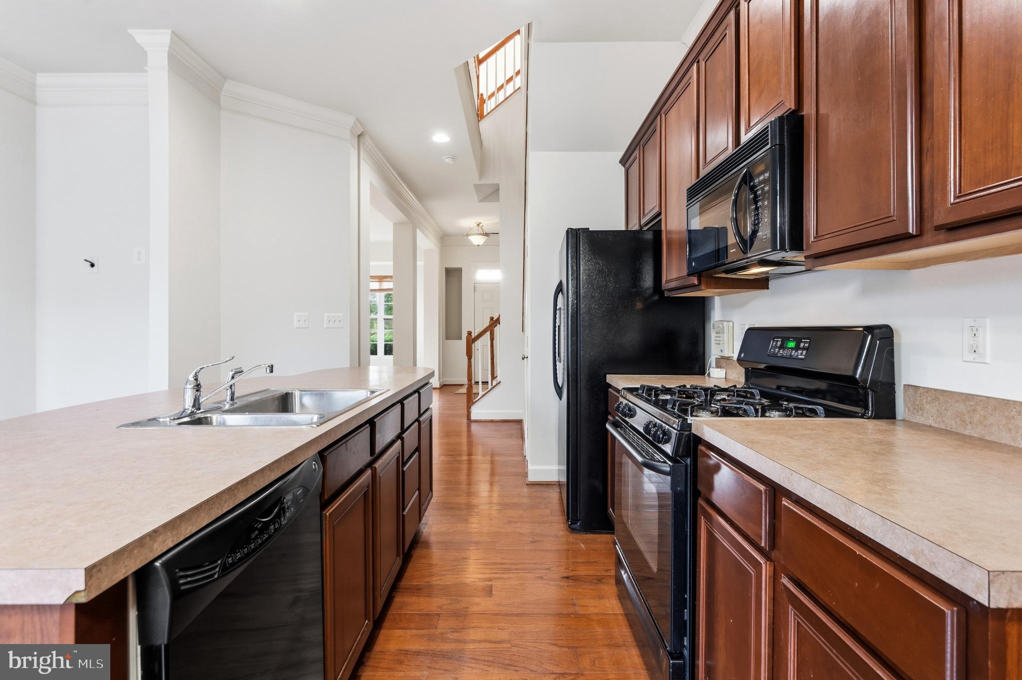 9227 Ribbon Falls Loop Bristow, VA 20136 - Photo 16 of 53 a kitchen with stainless steel appliances granite countertop a sink a stove and a refrigerator