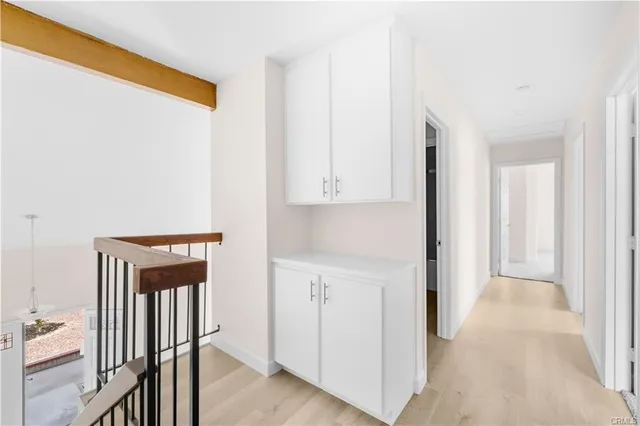 a view of a hallway with wooden floor