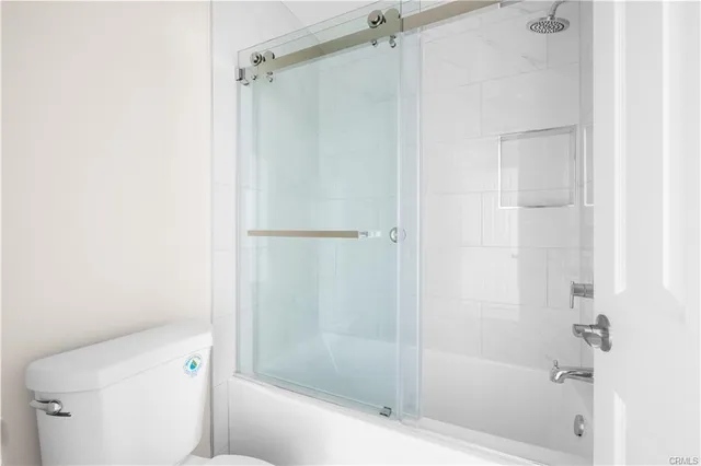 a bathroom with a shower and a toilet