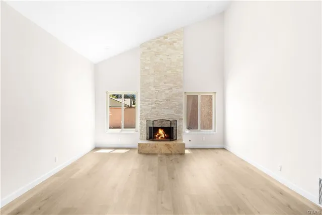 a view of a livingroom with a fireplace and window