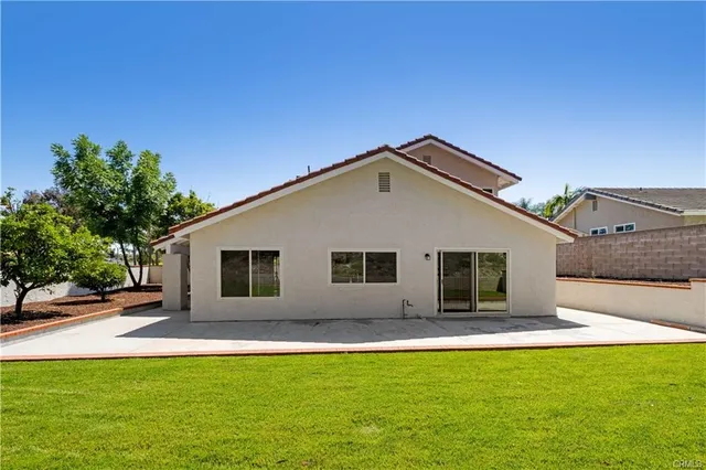 a house view with swimming pool in front of it