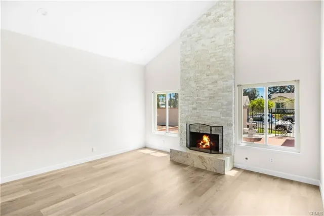 a living room with a fireplace and a floor to ceiling window
