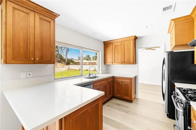 a kitchen with wooden cabinets and a refrigerator