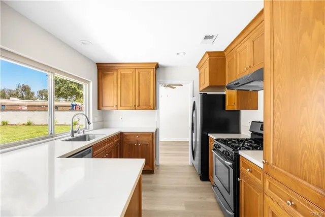 a kitchen that has a sink and a stove