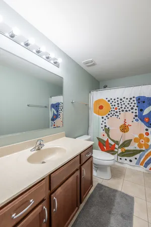 a bathroom with a sink mirror and vanity