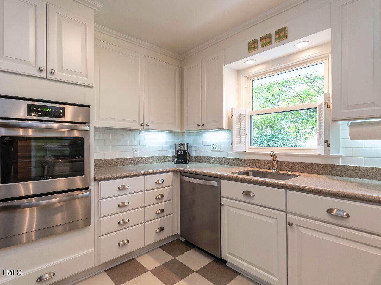 3510 Wordsworth Place Raleigh, NC 27609 - Photo 14 of 40 a kitchen with granite countertop cabinets stainless steel appliances and a window