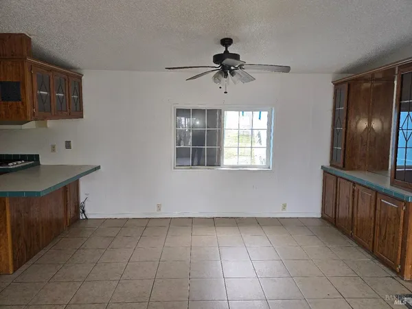 a view of a kitchen with a sink a dishwasher and wooden floor