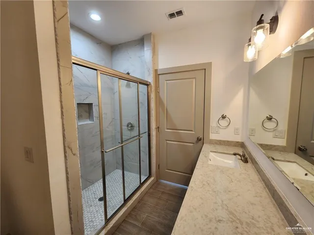 a bathroom with a tub and shower