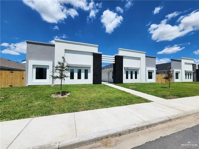 a view of a house with a backyard