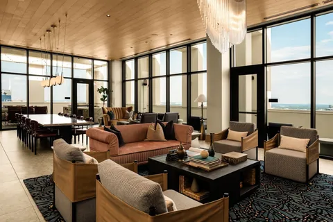 a living room with furniture large window and outdoor view