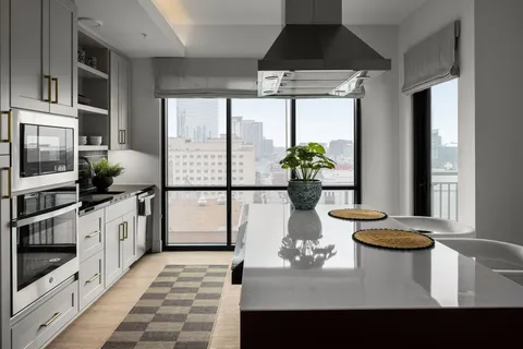 a kitchen with a sink stove and microwave