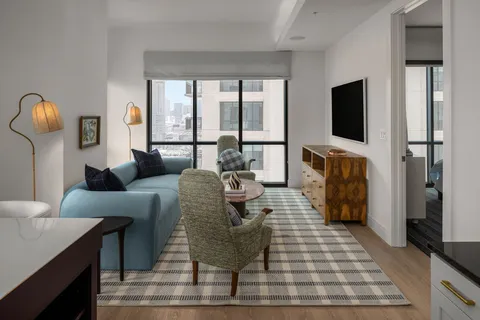 a living room with furniture fireplace and a flat screen tv