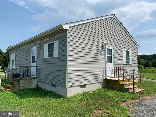 a view of backyard with a garden and deck