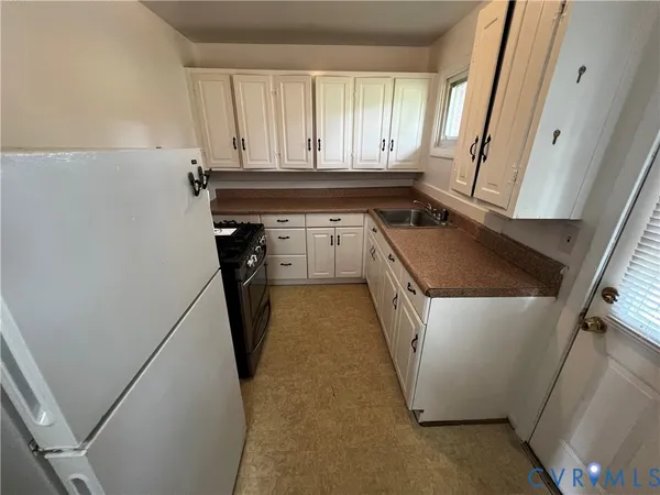 a kitchen with a sink a washer and dryer