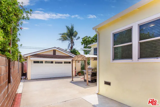 a view of white house with a garage