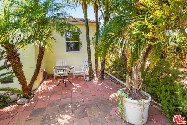 a view of a chairs and table in the patio