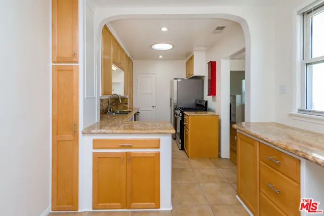 a kitchen with a sink stove and refrigerator