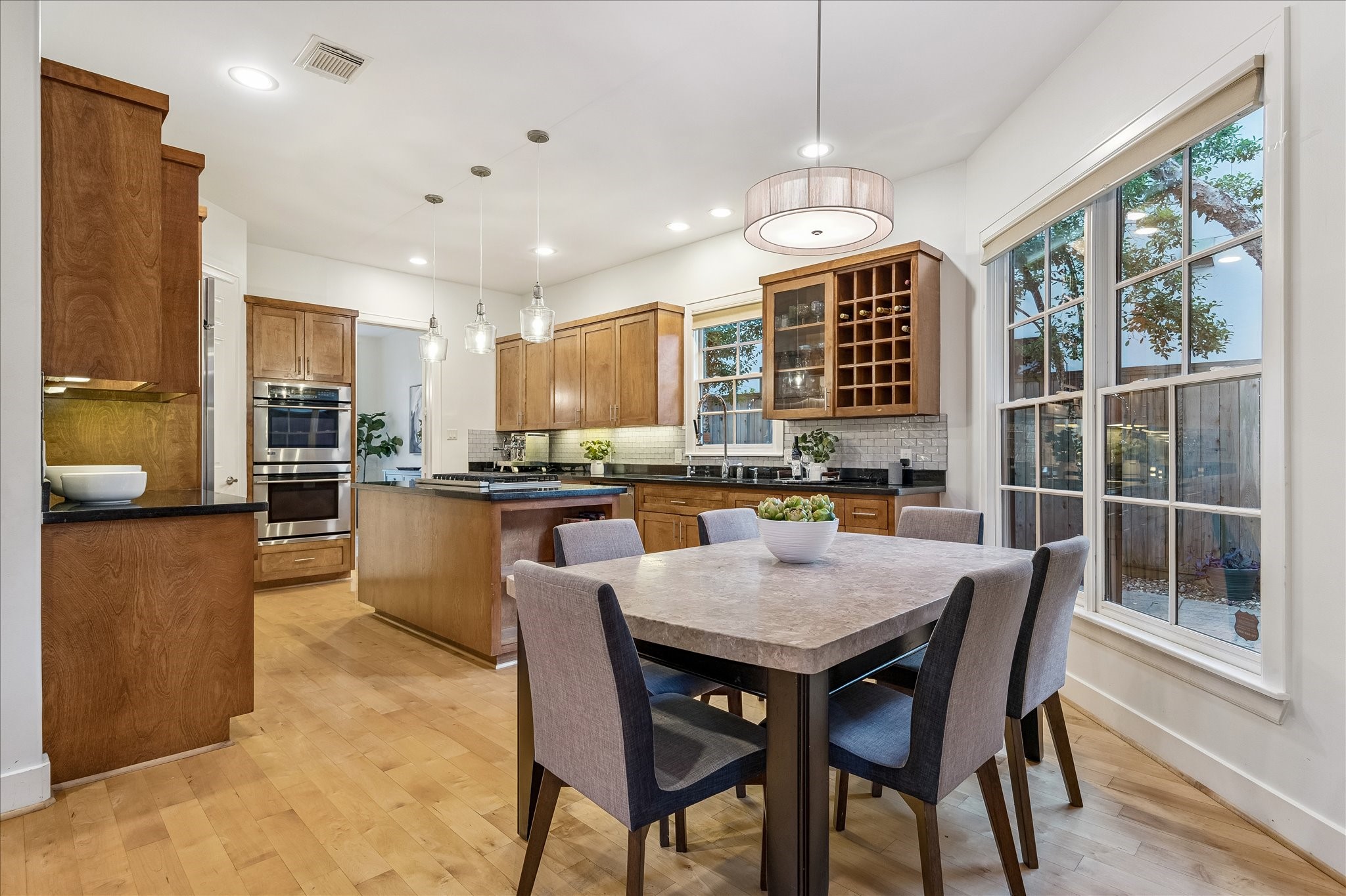 4010 Milton Street Houston, TX 77005 - Photo 11 of 49 BREAKFAST AREA. Note all the windows. Because this home has a wide footprint there is more space in the hallways and on either side of the home. This means a lot more natural light can come into the home.