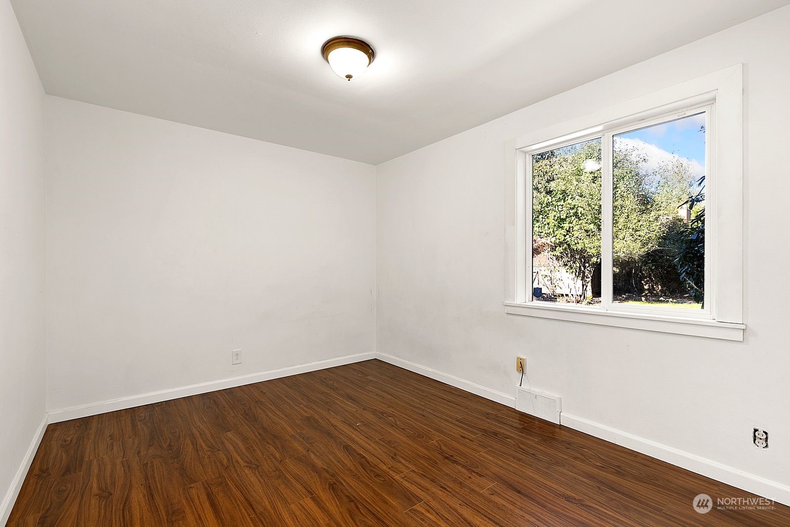 2336 North 135th Street Seattle, WA 98133 - Photo 13 of 17 an empty room with wooden floor and windows