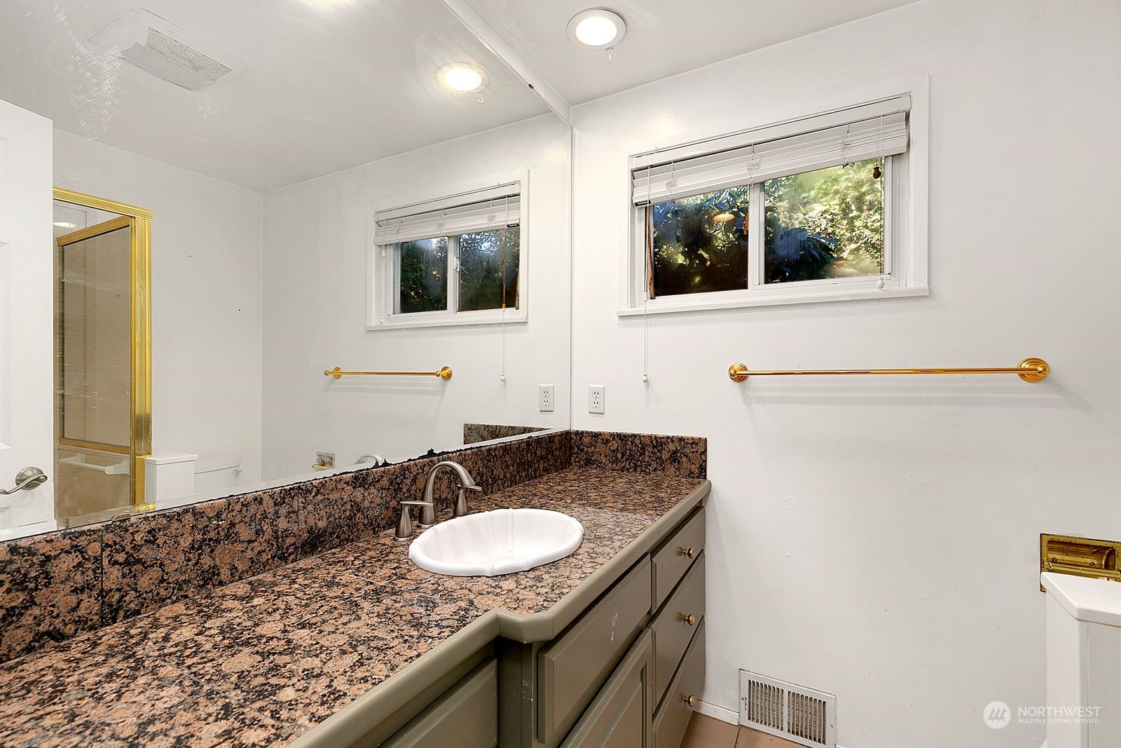 2336 North 135th Street Seattle, WA 98133 - Photo 14 of 17 a bathroom with a granite countertop sink and a mirror
