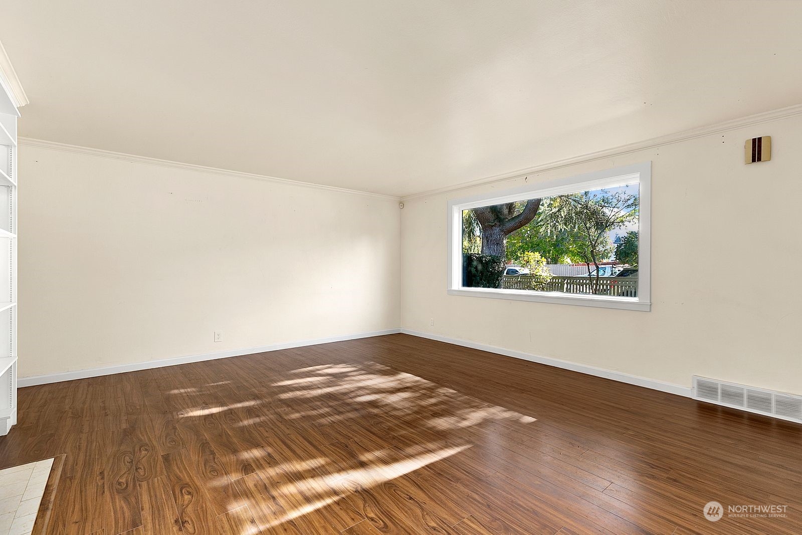 2336 North 135th Street Seattle, WA 98133 - Photo 3 of 17 an empty room with wooden floor and windows