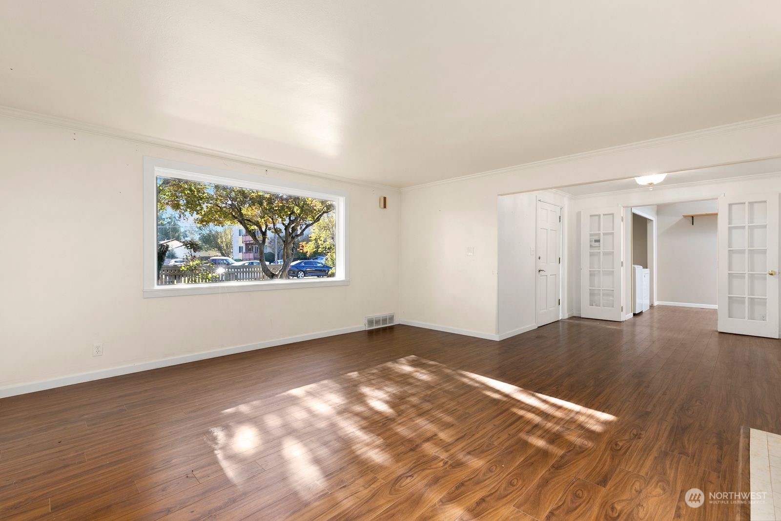 2336 North 135th Street Seattle, WA 98133 - Photo 4 of 17 an empty room with wooden floor and windows