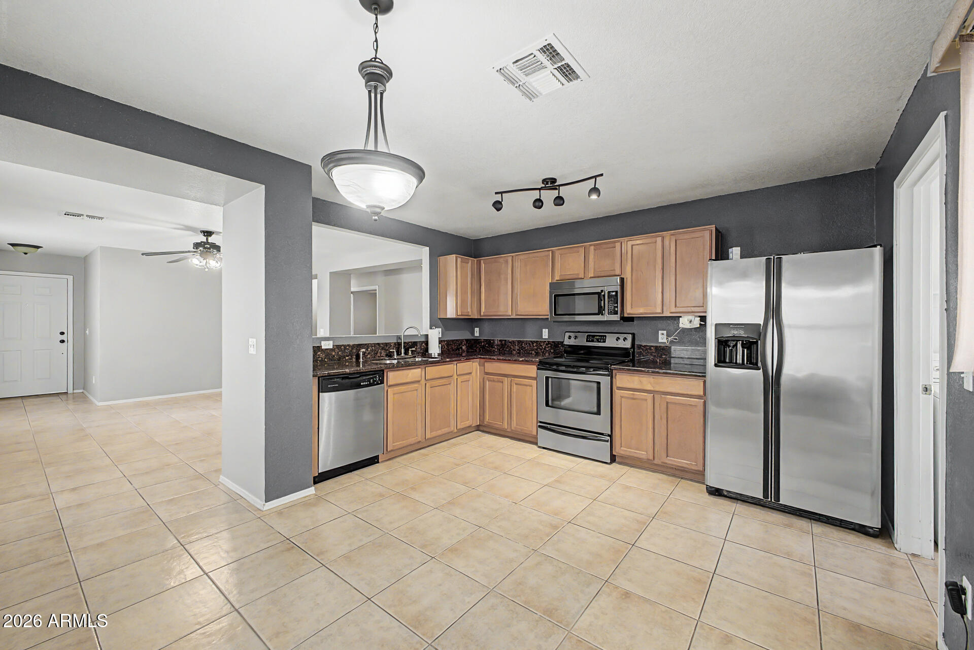 3489 South Bowman Road Apache Junction, AZ 85119 - Photo 2 of 24 a large kitchen with cabinets and stainless steel appliances