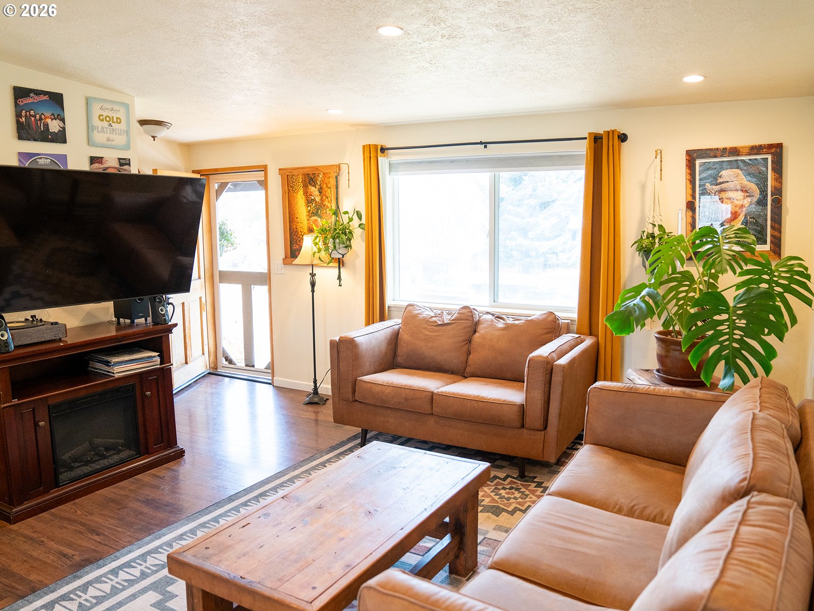 1923 Southwest 20th Street Redmond, OR 97756 - Photo 8 of 17 a living room with furniture a flat screen tv and a fireplace