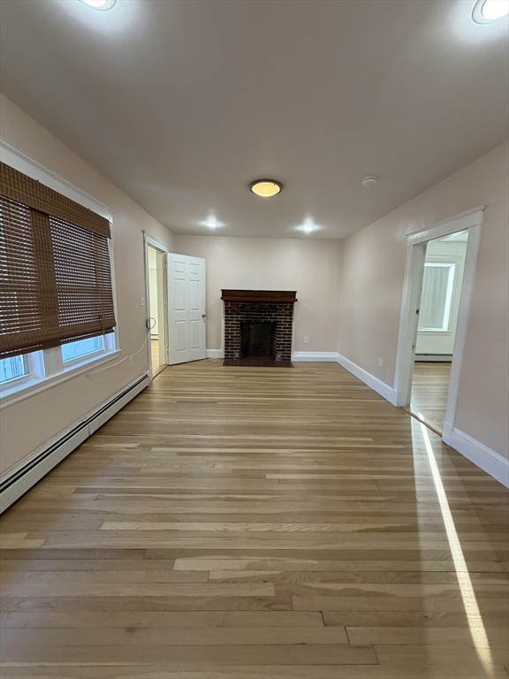 2 Buckingham Road Quincy, MA 02170 - Photo 1 of 10 a view of an empty room with wooden floor and a window