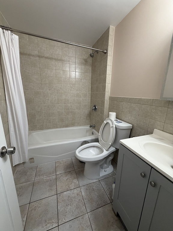 2 Buckingham Road Quincy, MA 02170 - Photo 2 of 10 a bathroom with a granite countertop bathtub shower sink and toilet