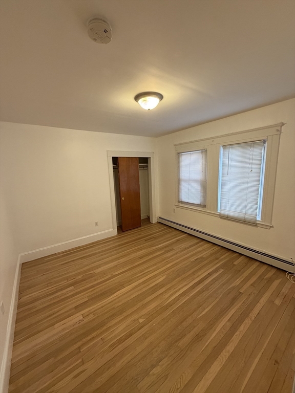 2 Buckingham Road Quincy, MA 02170 - Photo 7 of 10 a view of an empty room with wooden floor and a window