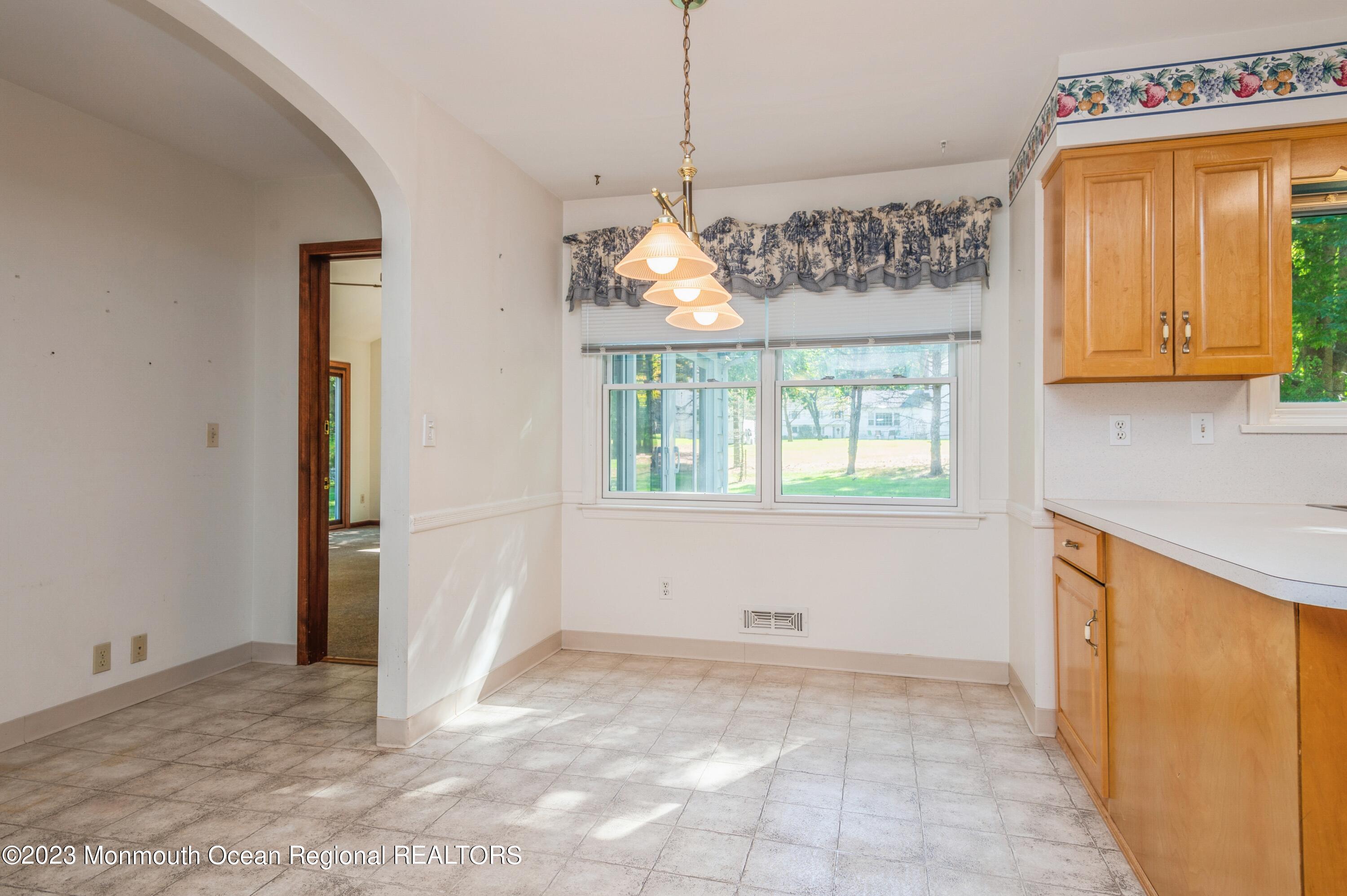 43 McCampbell Road Holmdel, NJ 07733 - Photo 11 of 25 a view of a kitchen with a window and a chandelier