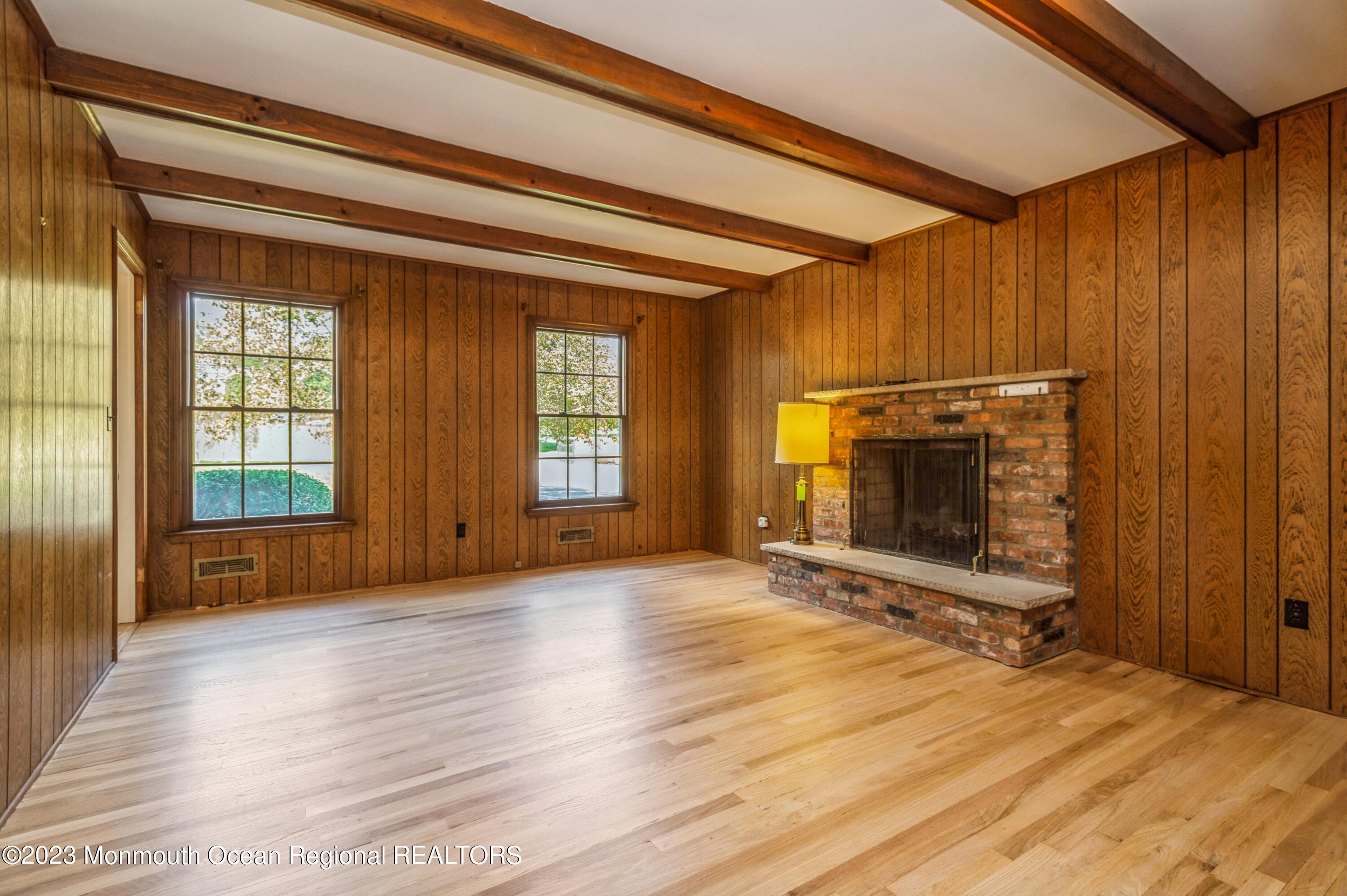43 McCampbell Road Holmdel, NJ 07733 - Photo 12 of 25 a view of an empty room with a fireplace and a window