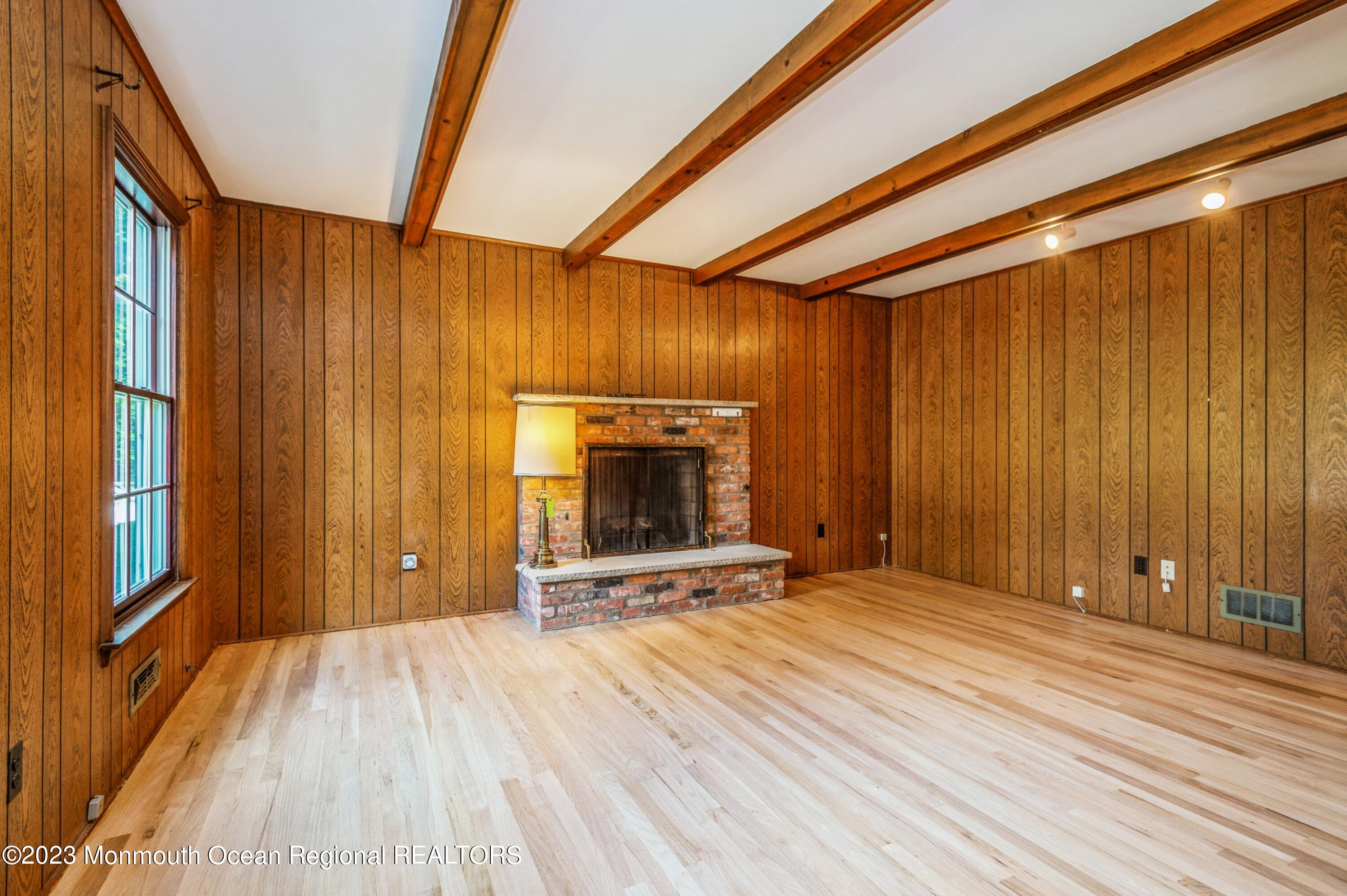 43 McCampbell Road Holmdel, NJ 07733 - Photo 13 of 25 a view of an empty room with wooden floor and a window
