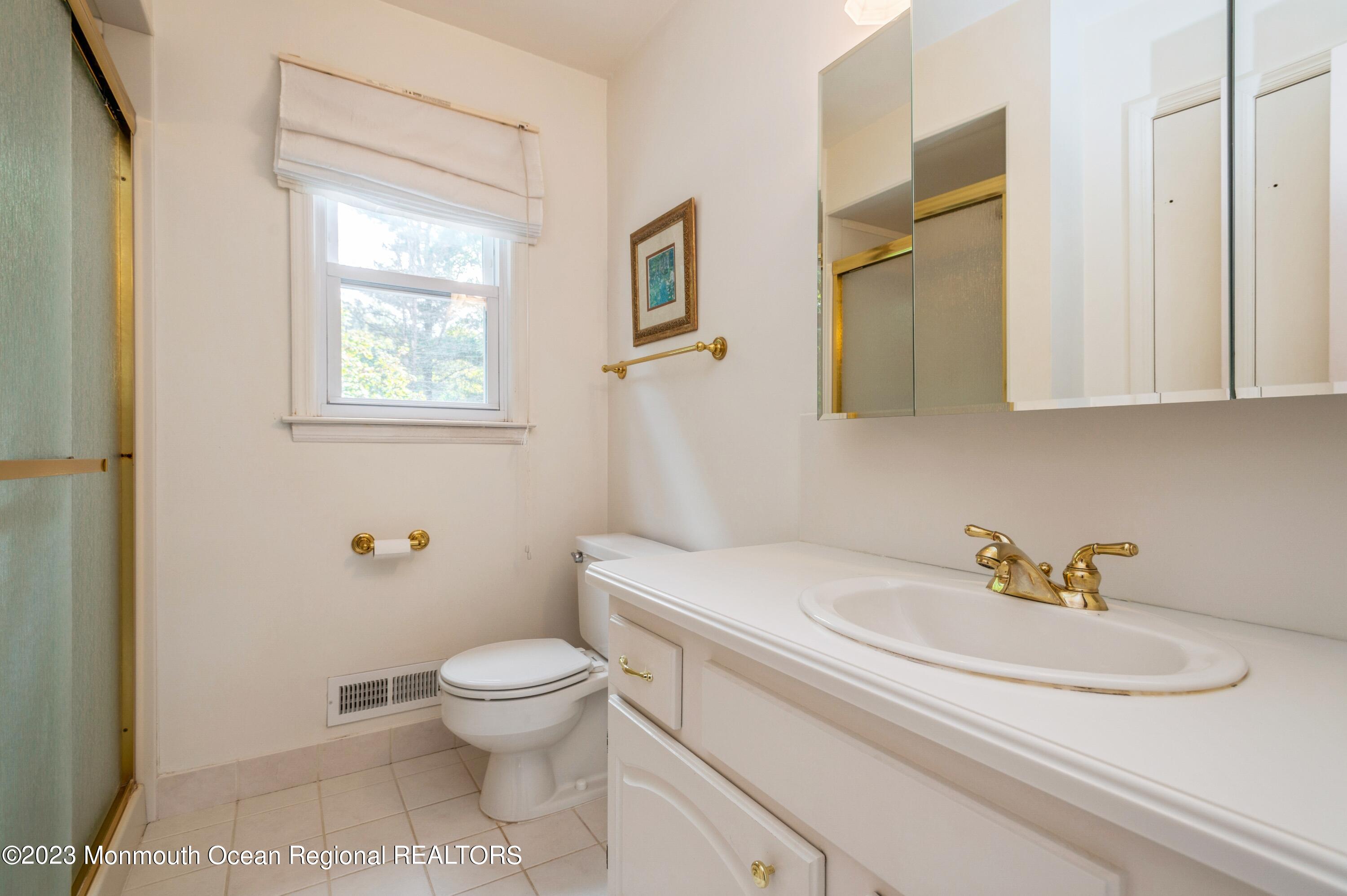 43 McCampbell Road Holmdel, NJ 07733 - Photo 17 of 25 a bathroom with a sink toilet and a mirror
