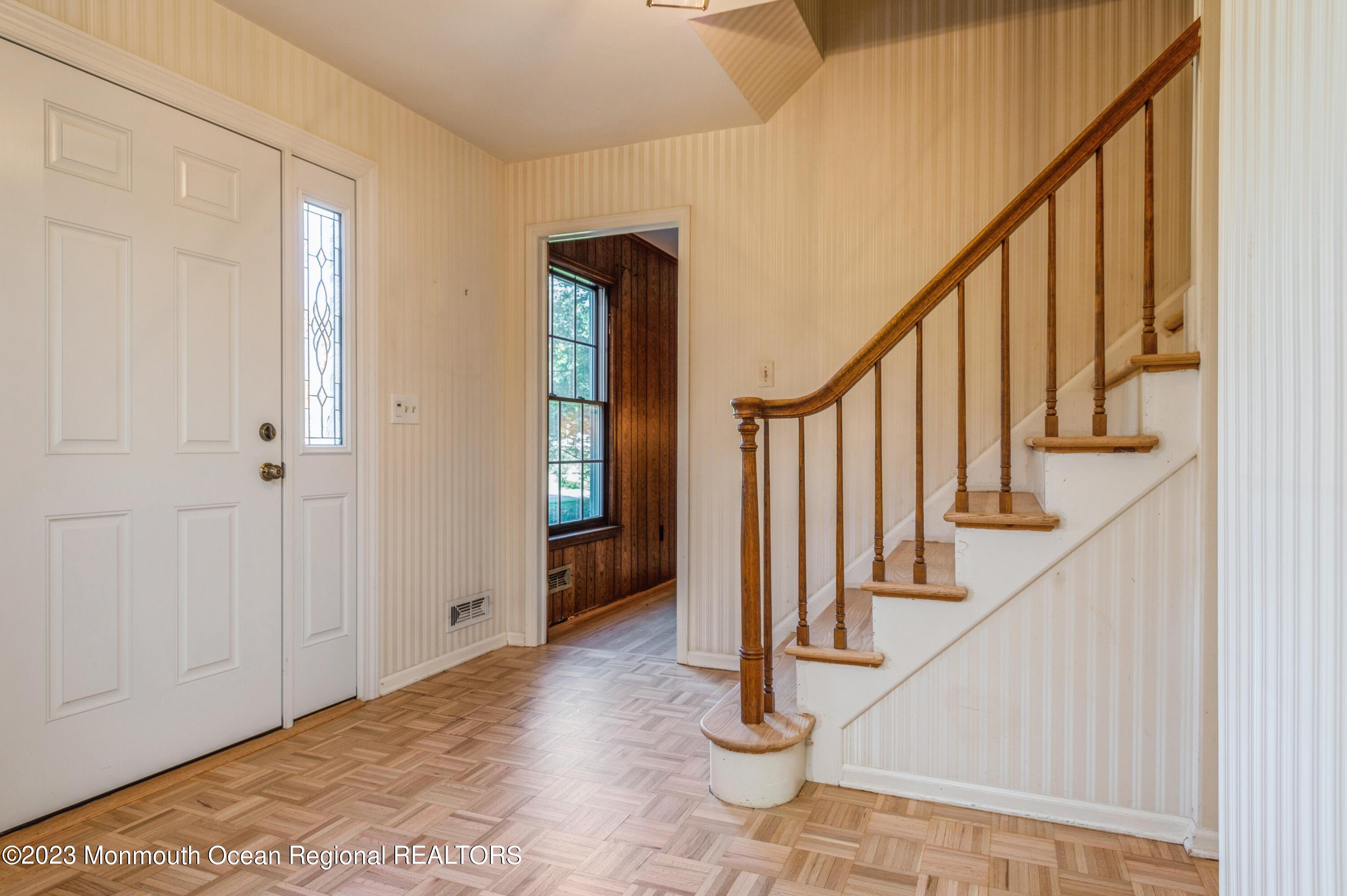 43 McCampbell Road Holmdel, NJ 07733 - Photo 4 of 25 a view of entryway with wooden floor and stairs