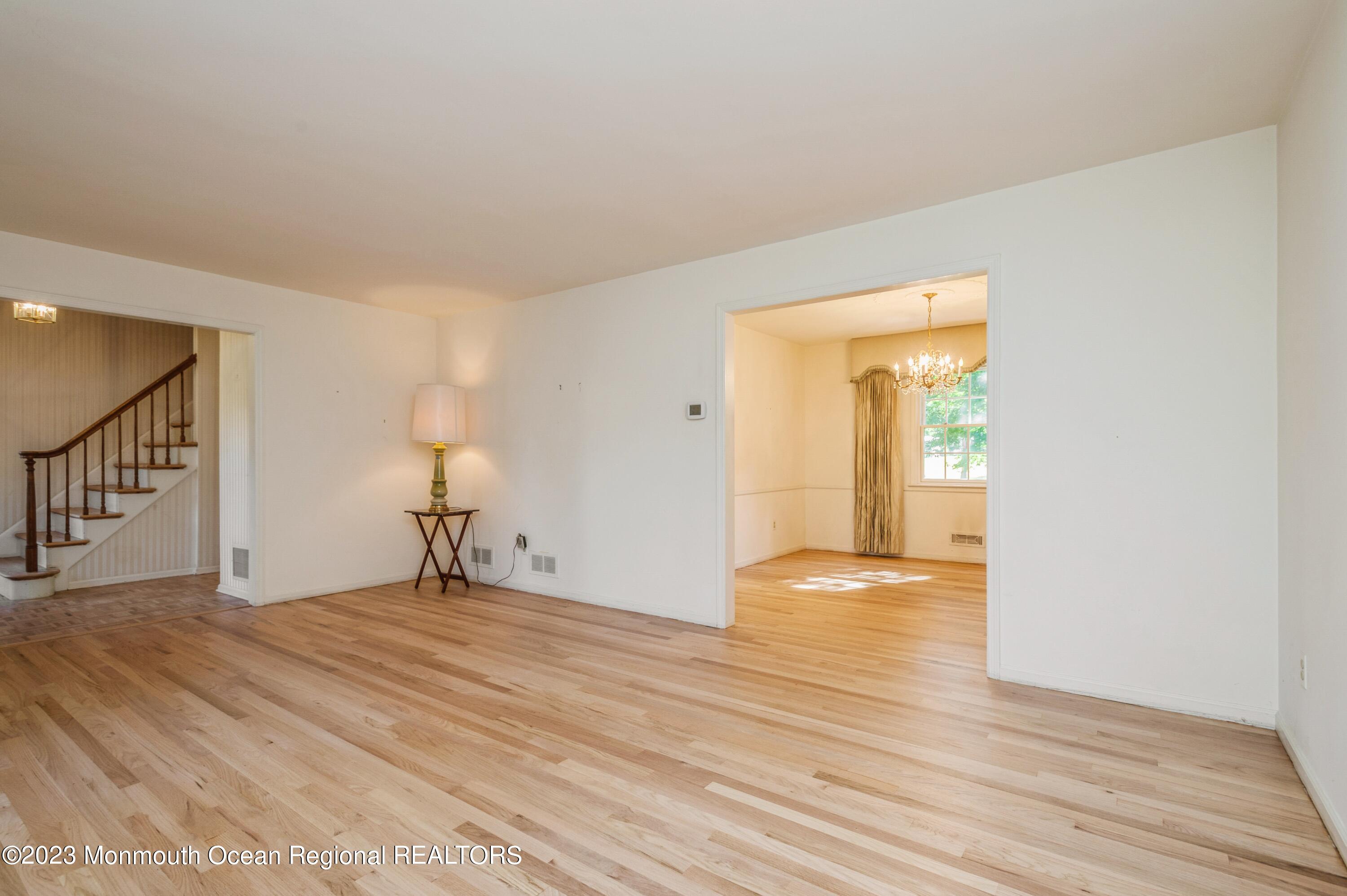 43 McCampbell Road Holmdel, NJ 07733 - Photo 5 of 25 a view of an empty room with wooden floor and a window