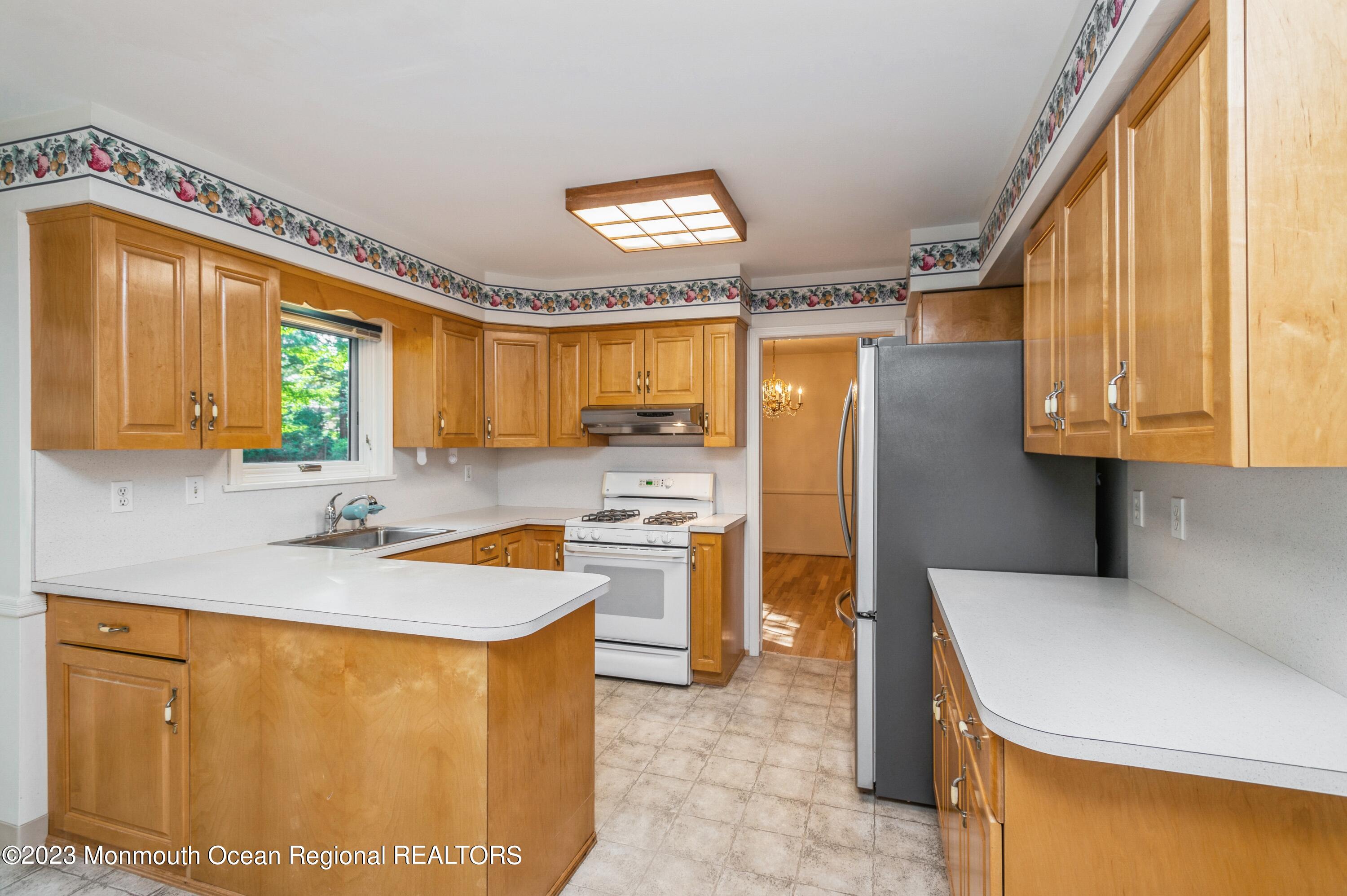 43 McCampbell Road Holmdel, NJ 07733 - Photo 10 of 25 a kitchen with a sink a refrigerator and cabinets