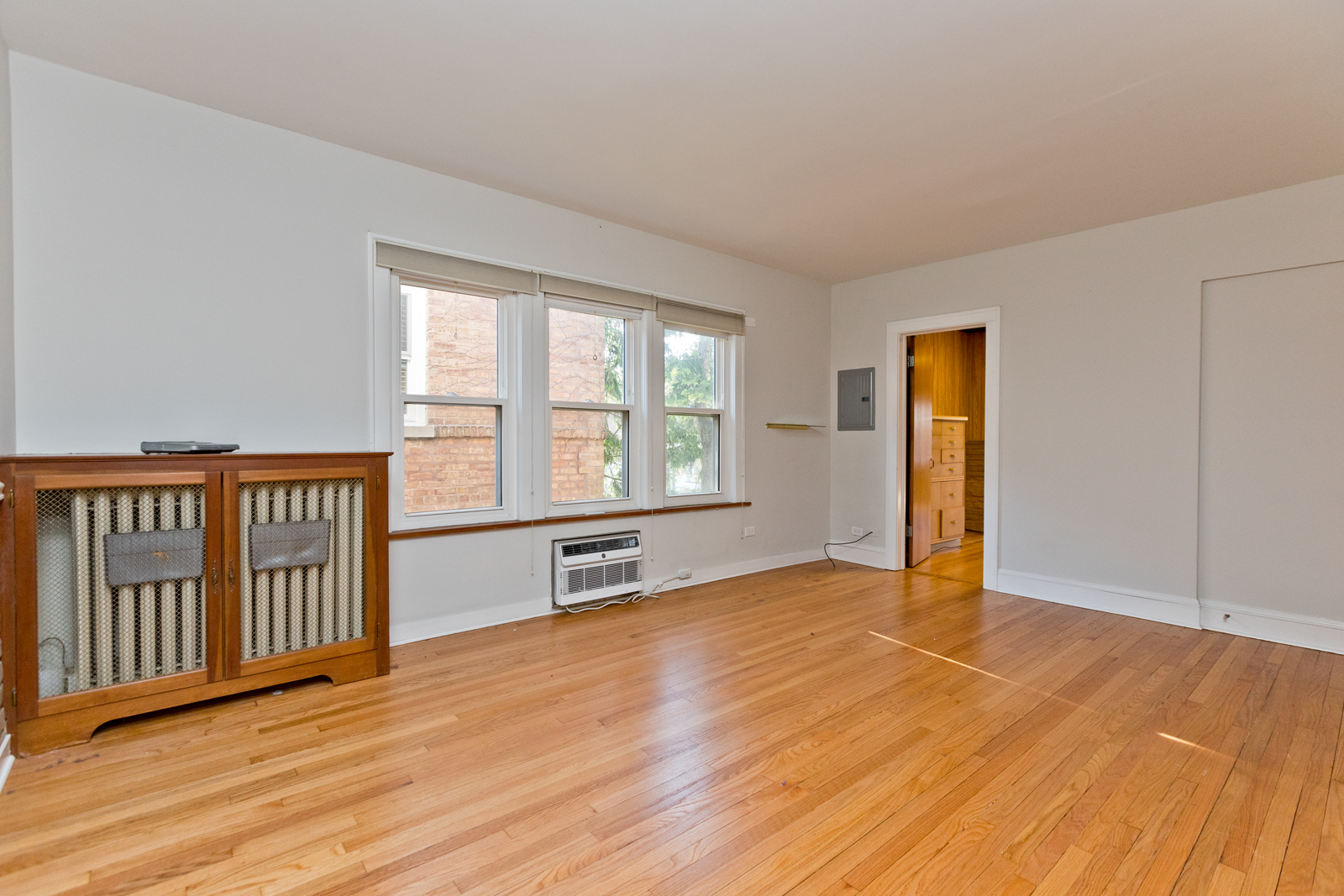 2950 Central Street, Unit 2 Evanston, IL 60201 - Photo 11 of 17 an empty room with wooden floor and windows