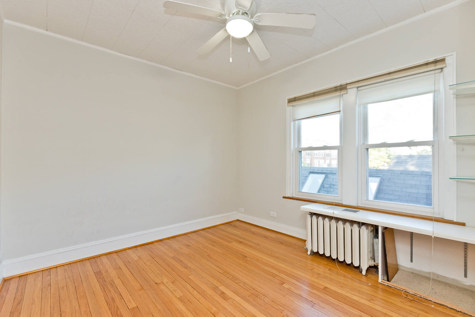 2950 Central Street, Unit 2 Evanston, IL 60201 - Photo 14 of 17 an empty room with wooden floor fan and windows